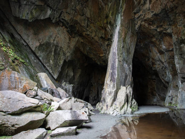 The main chamber of Cathedral Cave in Little Langdale, lit by natural rock windows, Lake District